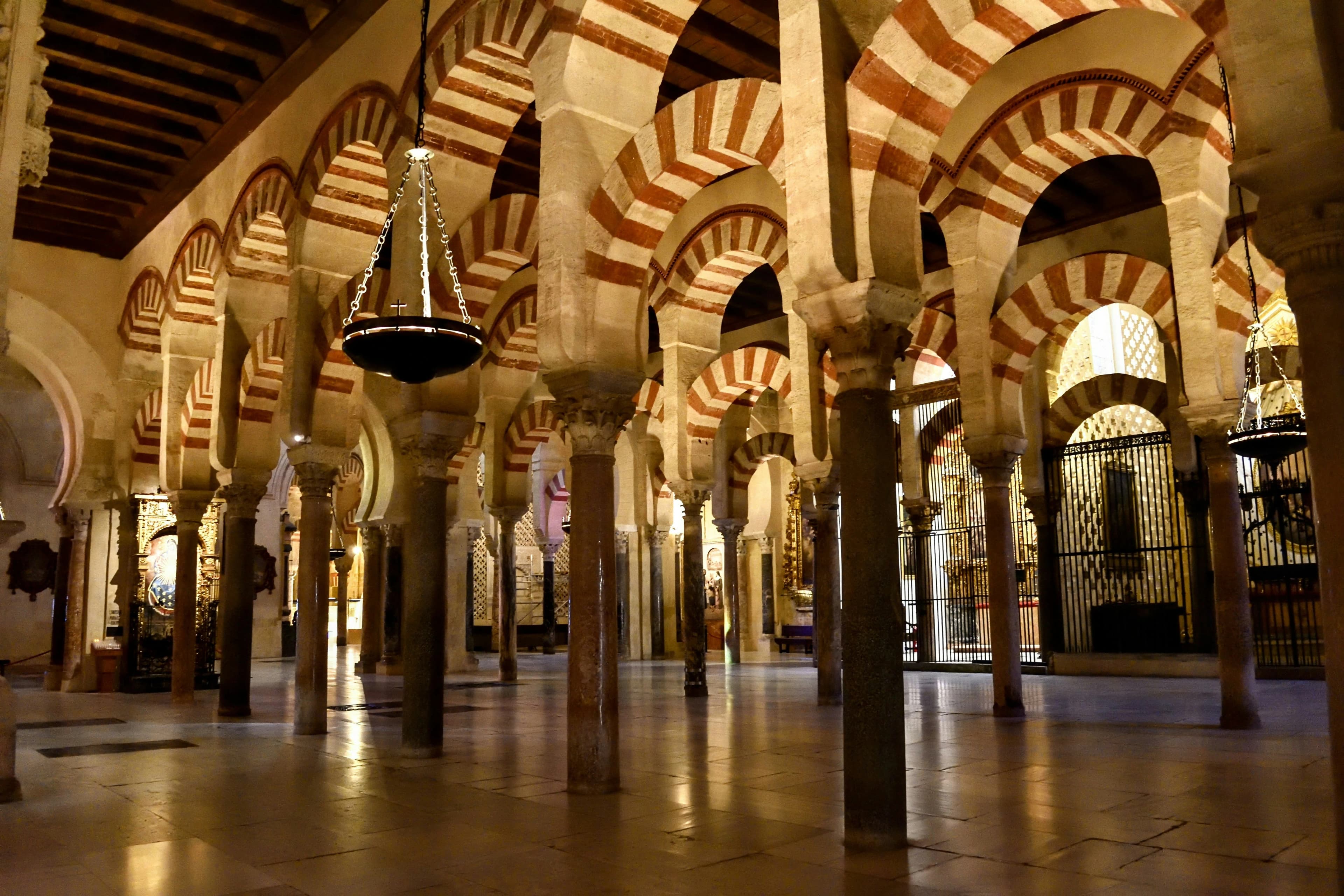 The double-tiered, horseshoe arches of the Mezquita in Córdoba, Spain. A breathtaking fusion of light, stone, and centuries of cultural history