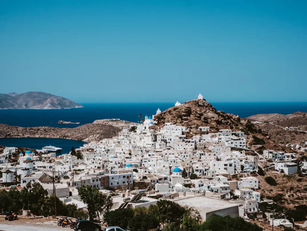 The picturesque main town of Ios, a classic Greek Cycladic village, is a cascade of white buildings clinging to a hillside.