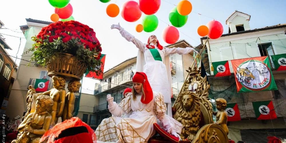 A vibrant float parade with a large floral arrangement and people in historical costumes moves through the city streets.