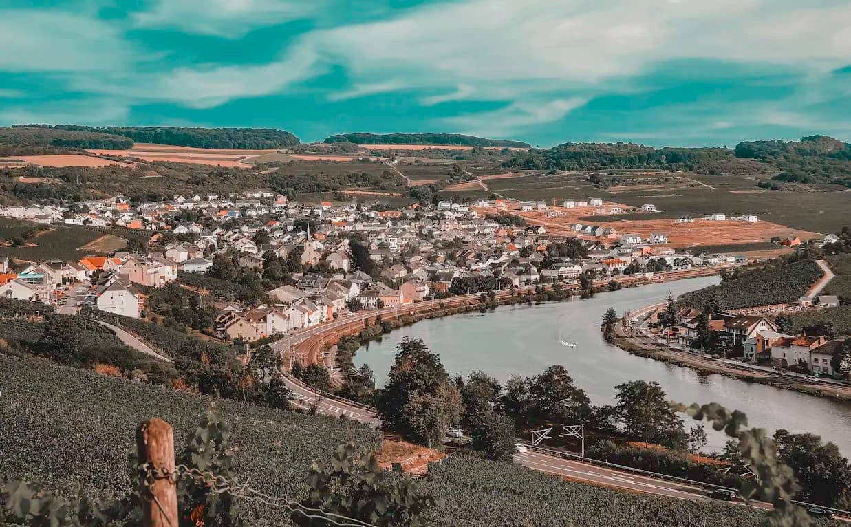 The magnificent Trier Cathedral, with its large spires and gothic architecture, is a beautiful sight against a clear blue sky.