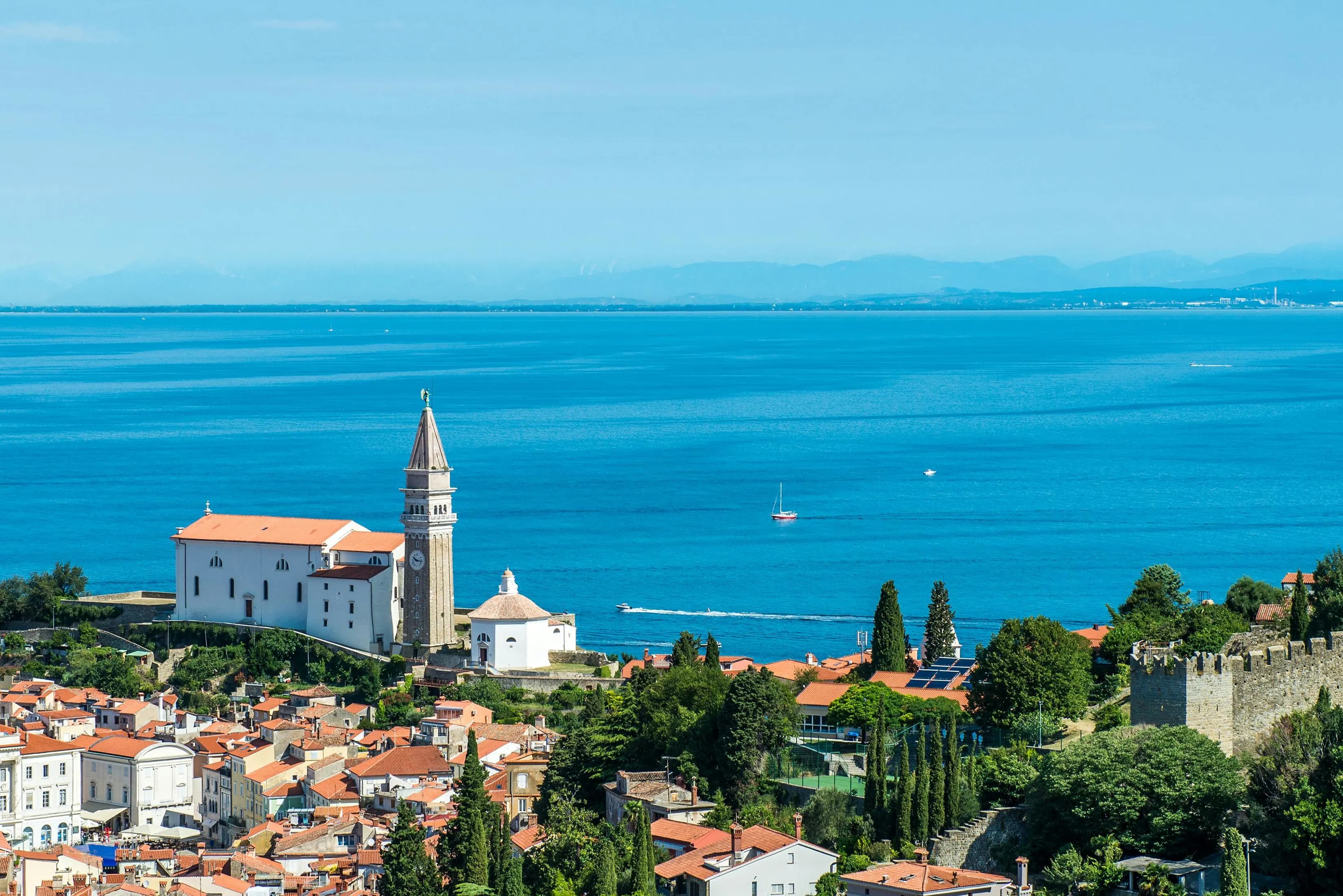 The magnificent Piazza Unità d'Italia, a grand public square with elegant buildings, is a beautiful backdrop to a bustling city street.