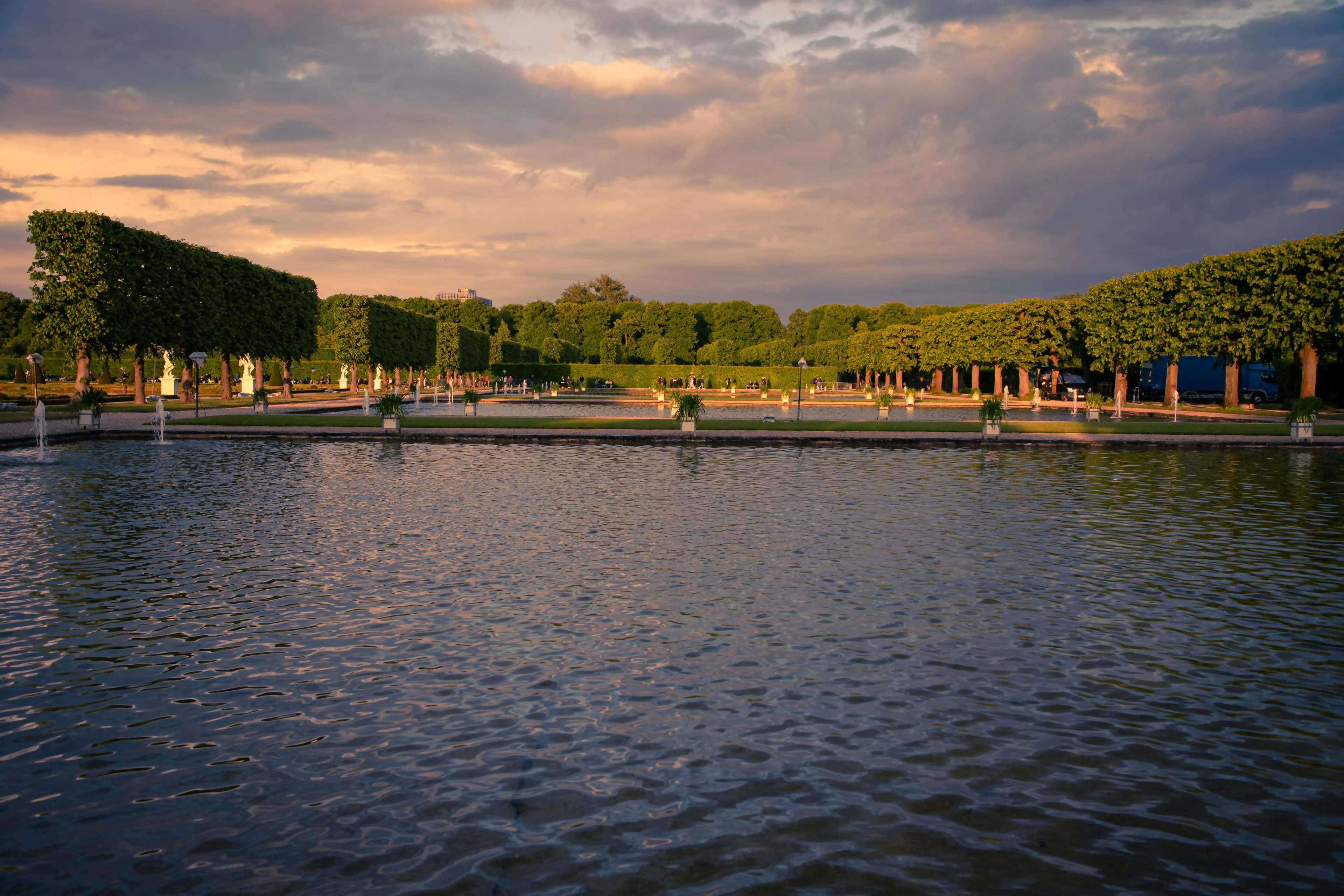 The gardens of the Château de la Belle au Bois Dormant, with a large, tranquil pond and manicured bushes, are a peaceful escape.