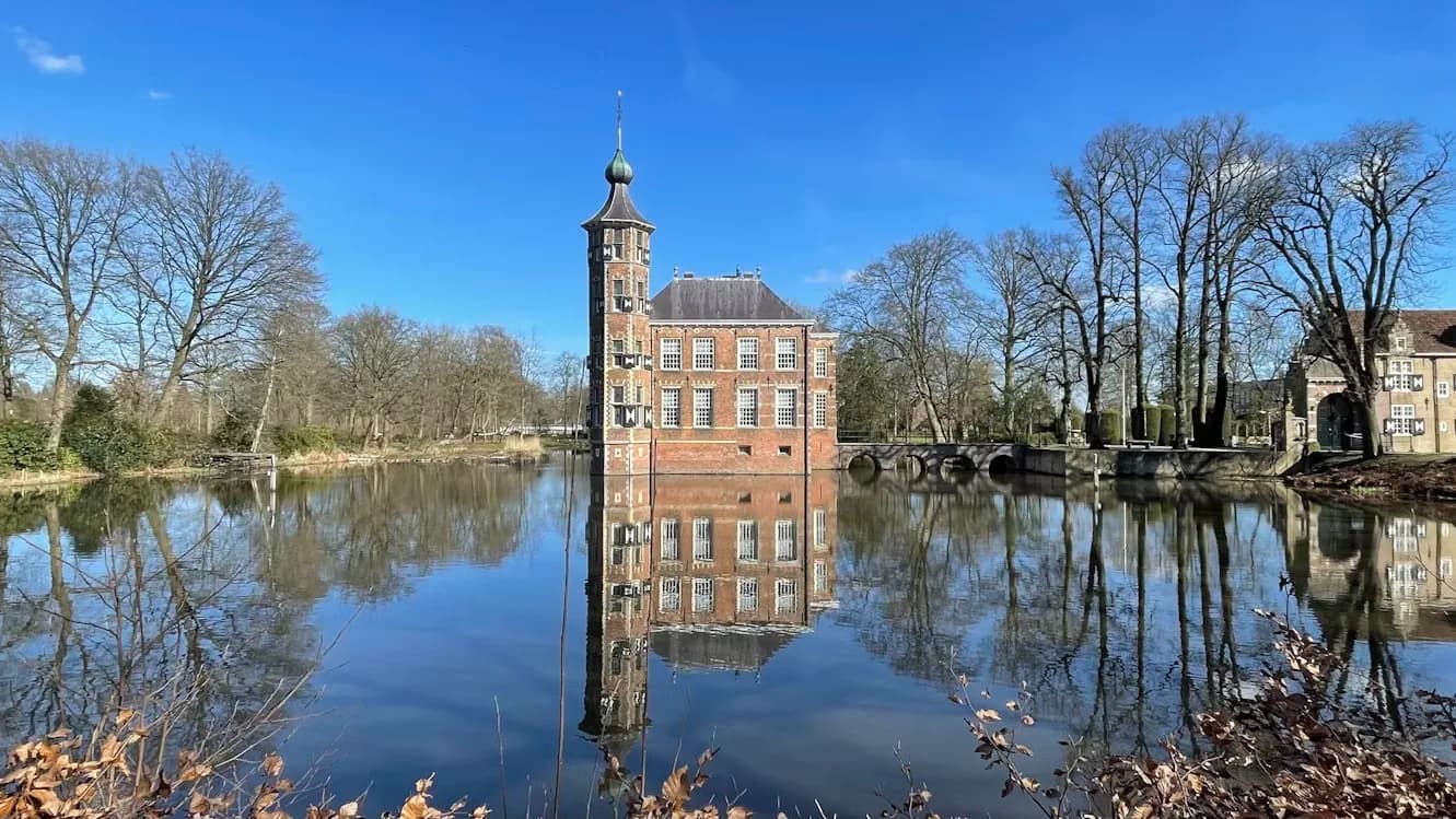 The historic Kasteel van Breda, or Breda Castle, is beautifully reflected in the calm waters of a surrounding moat.