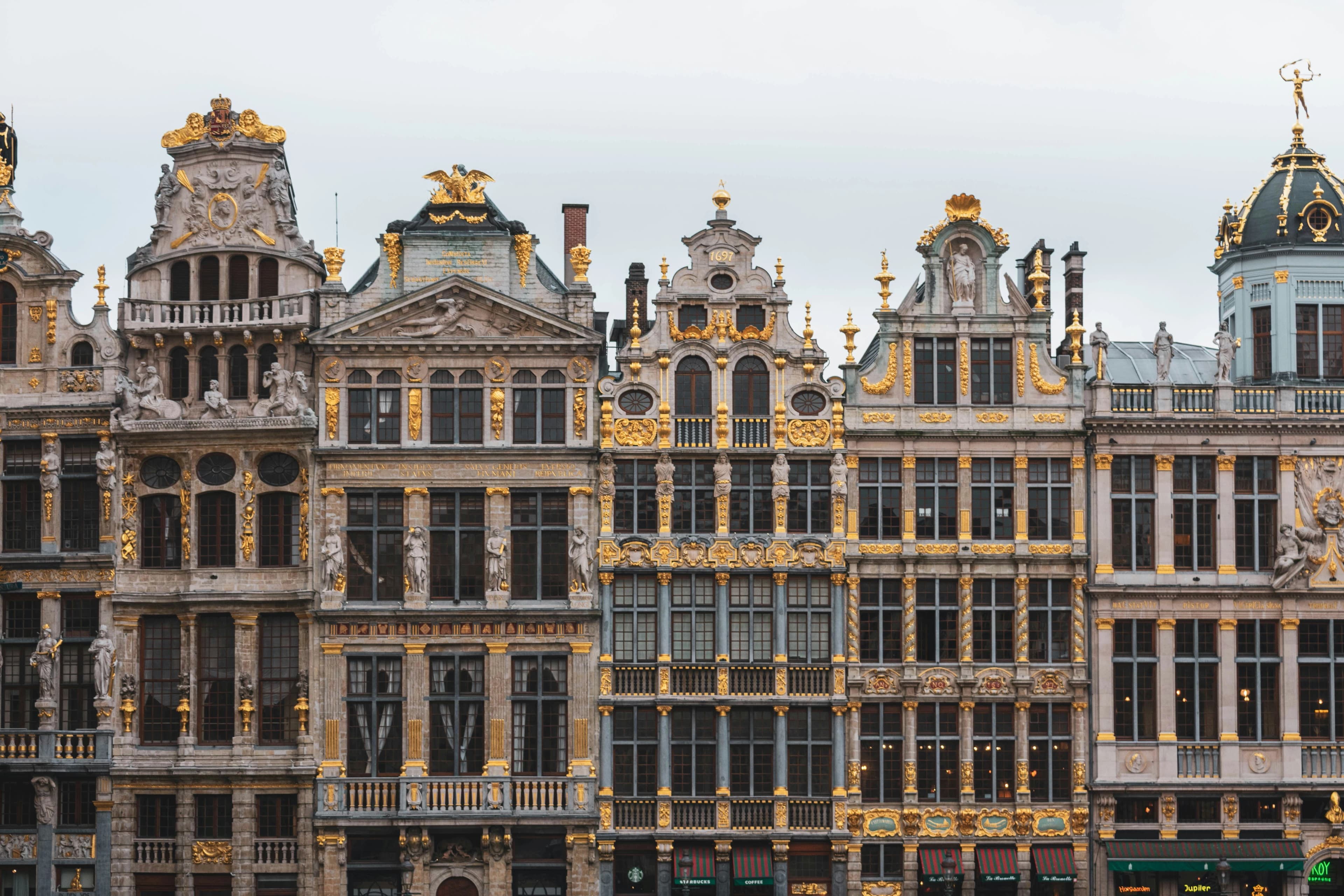 A close-up of the ornate, gilded facades of the guildhalls in the Grand Place, showcasing their exquisite details.