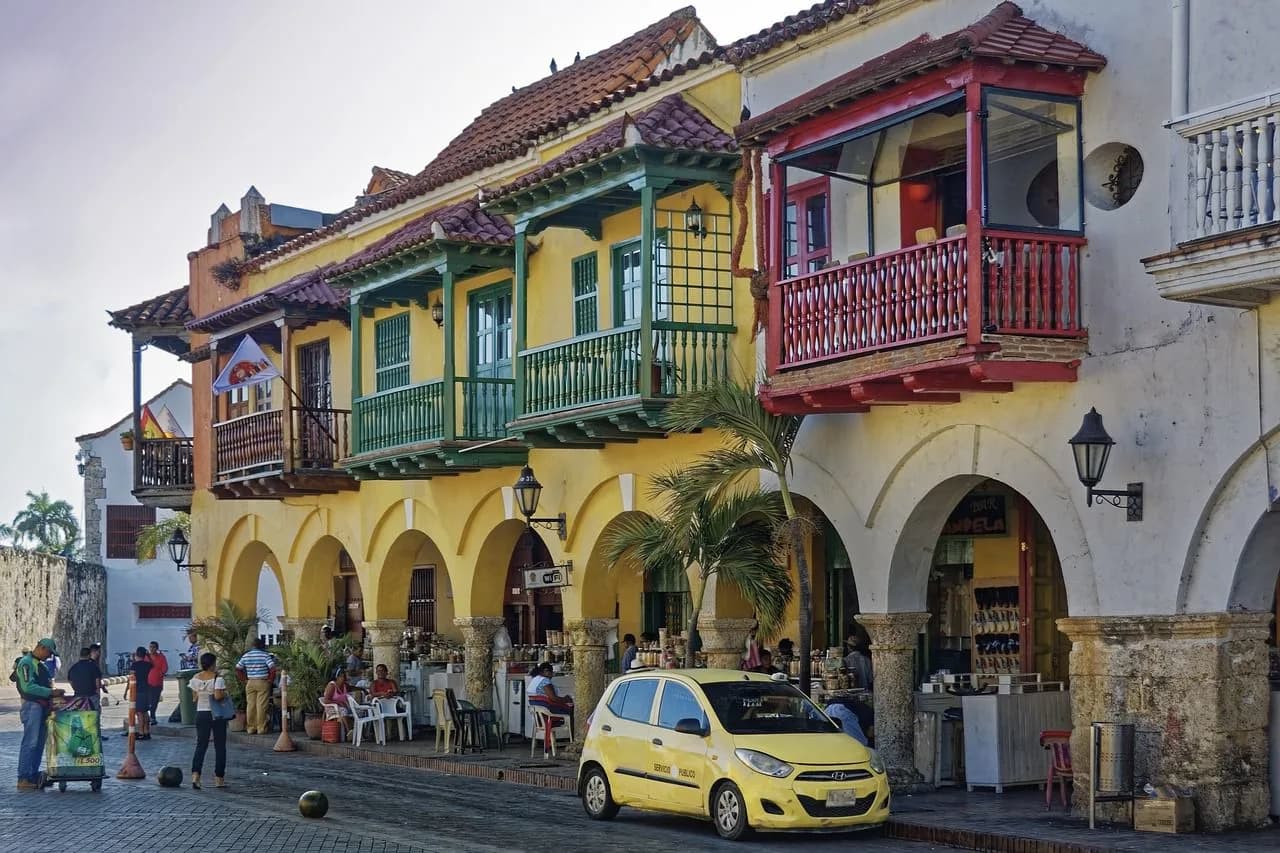 The colorful, colonial-style buildings with intricate balconies line a street, creating a vibrant and historic scene in the Old Town.