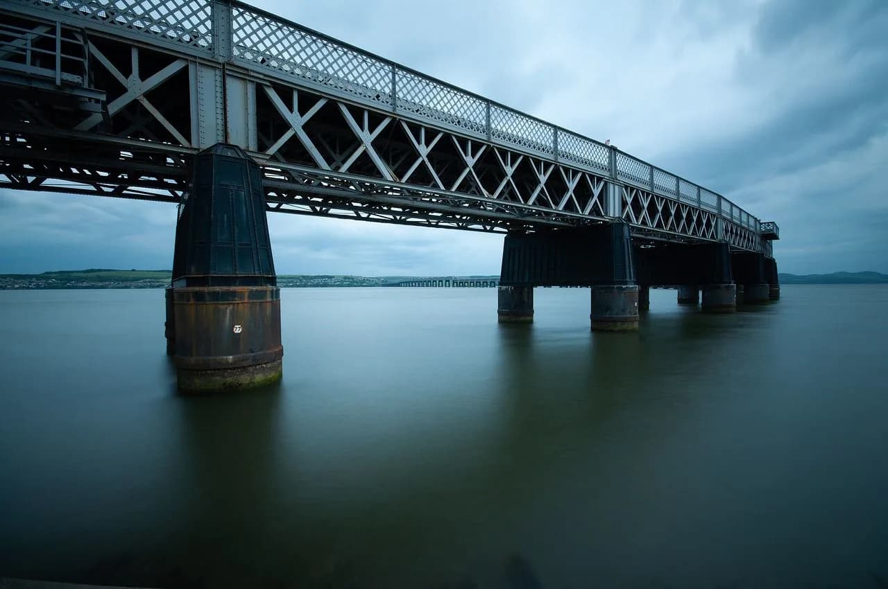 The majestic Tay Rail Bridge, an imposing feat of engineering, spans the wide waters of the Firth of Tay.