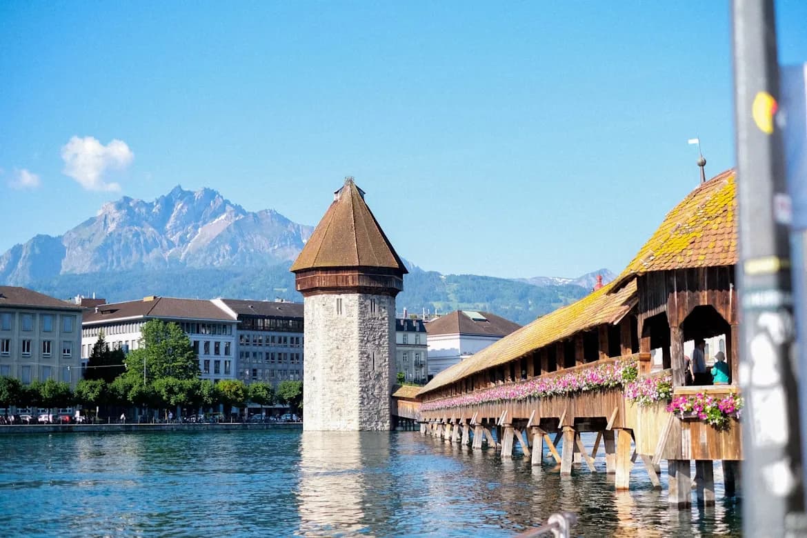 The iconic Chapel Bridge, a historic wooden bridge with a water tower, is a prominent landmark on the Reuss River.