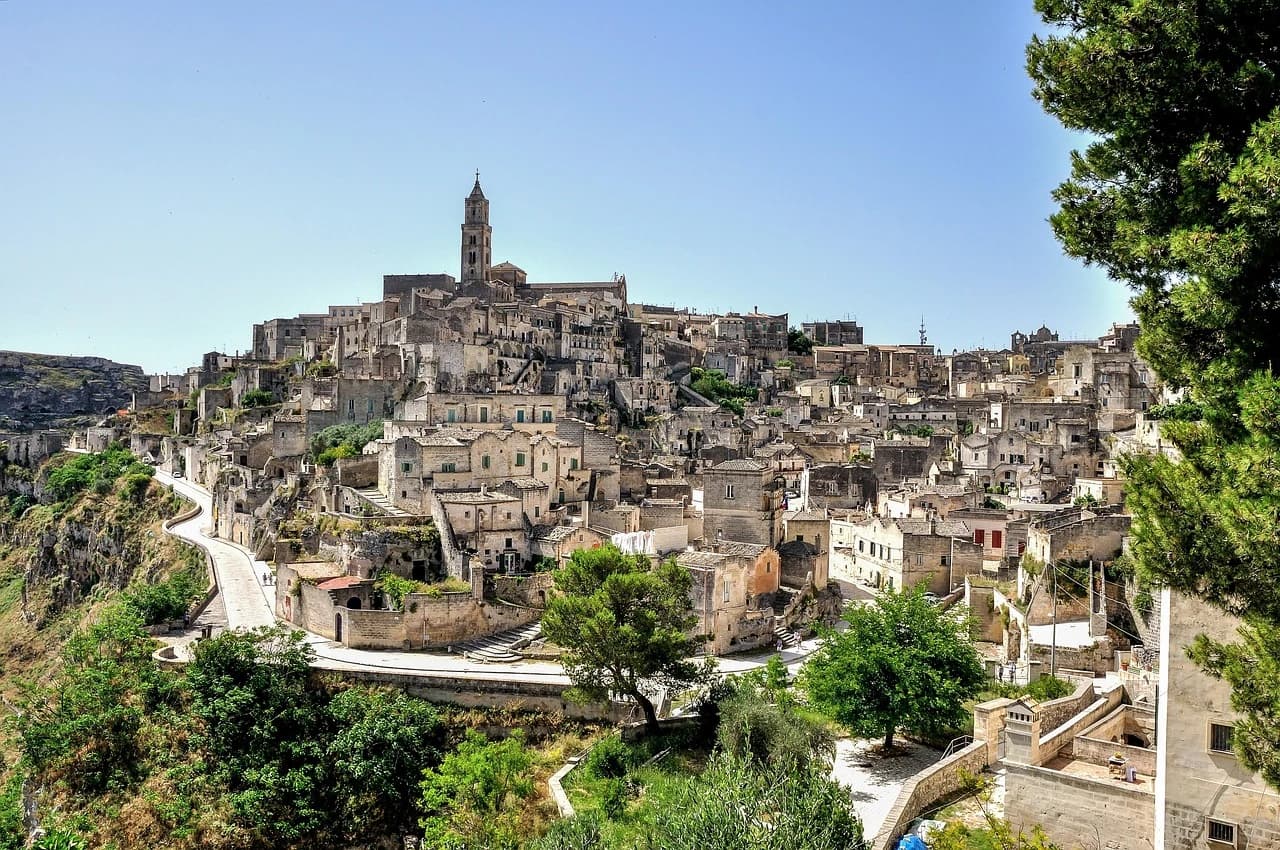 The historic city of Matera is a unique blend of ancient cave dwellings and traditional buildings, with a bell tower rising from the hill.