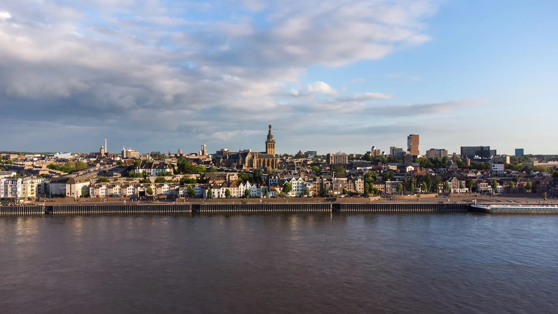 A quiet city street in Nijmegen is lined with traditional brick houses and a few small cafes.