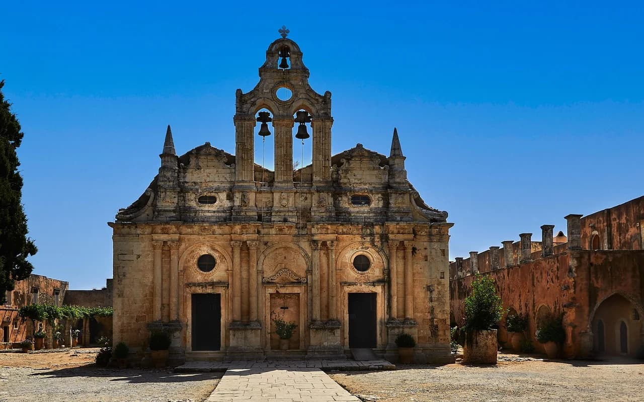 The historic Arkadi Monastery, a magnificent stone building with a bell tower and arches, is a testament to the region's cultural heritage.